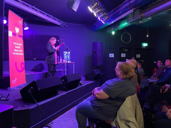 Antje performing at a spoken word event.